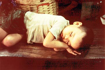 Sleeping child in a market in Manila.  Taken on a trip with Barbara Bagwell.
